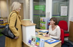 Photograph of a woman getting advice at a walk in community legal advice centre