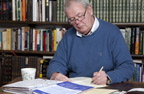 Photograph of man doing paperwork
