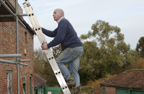 3. Photograph of a man up a ladder